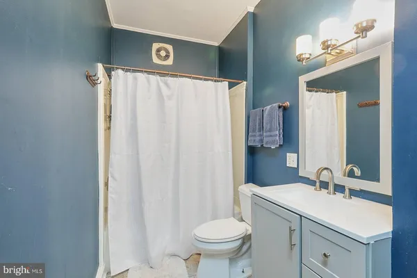 a view of bathroom with toilet and a window