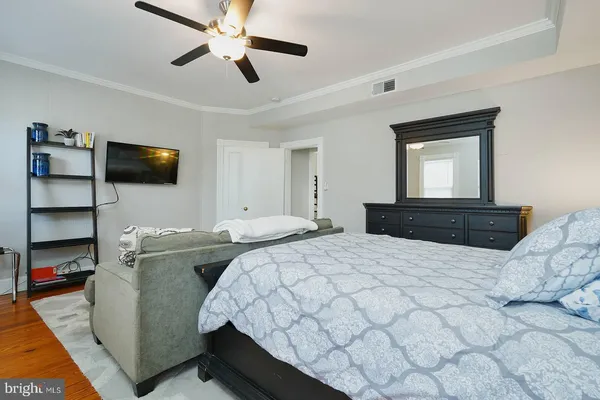 a bedroom with a bed and painting on the wall