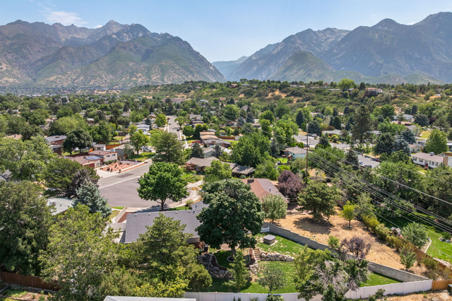 2370 Quail Run Circle East Sandy, UT 84093 - Photo 50 of 54 Mountain backdrop framing a residential area with mature trees and a clear sky