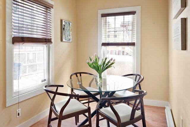 a view of a dining room with furniture and a window