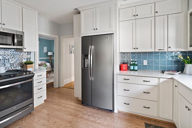 a kitchen with stainless steel appliances granite countertop a refrigerator stove and sink