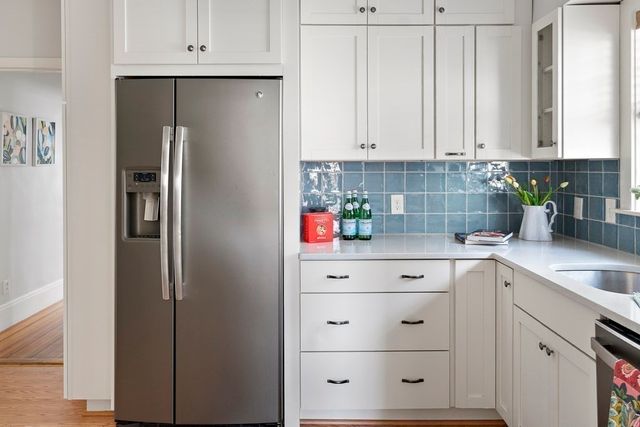 a white refrigerator freezer sitting inside of a kitchen