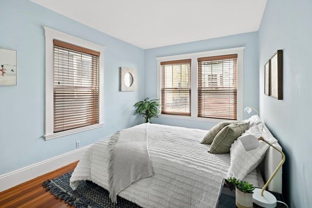 a bedroom with a bed and windows