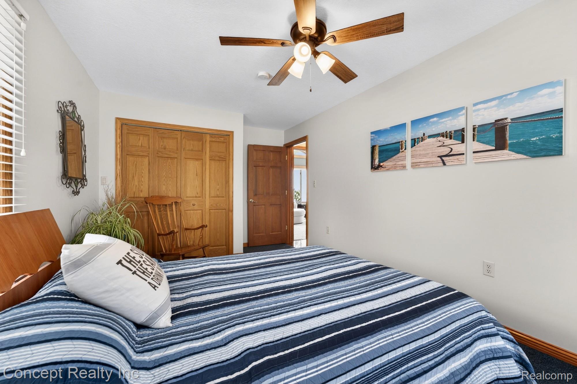 4720 Long Road Newport, MI 48166 - Photo 23 of 46 Bedroom with ceiling fan, a closet, and carpet floors