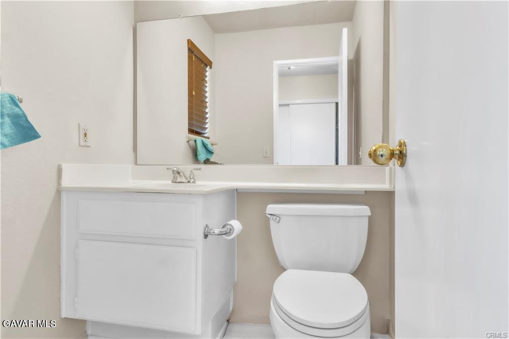2309 Gregory Avenue Palmdale, CA 93550 - Photo 12 of 29 a bathroom with a toilet sink and mirror