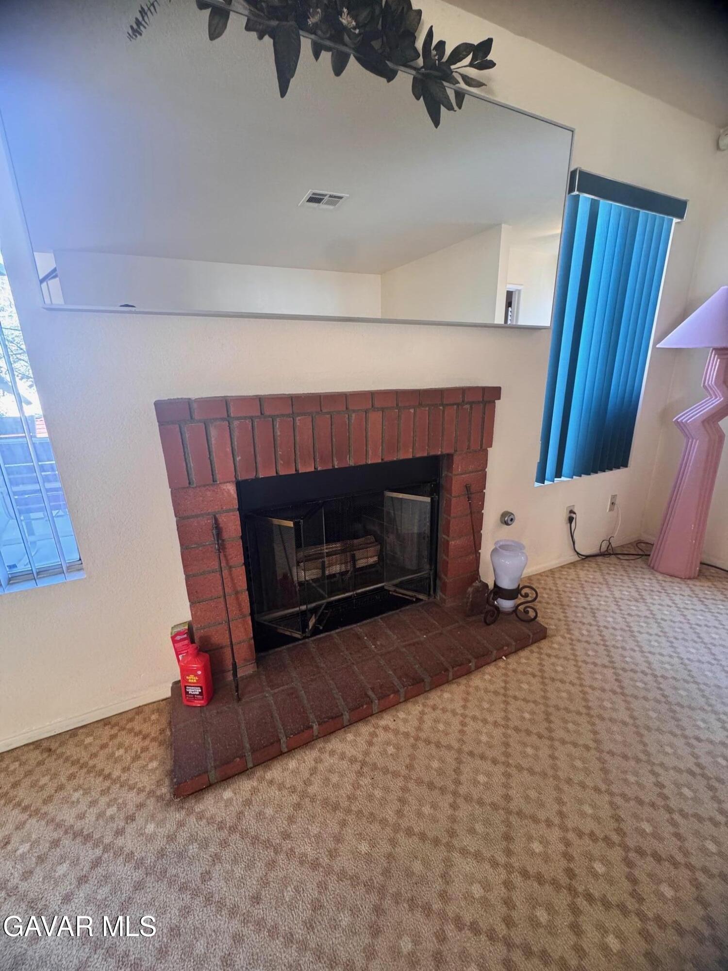 2309 Gregory Avenue Palmdale, CA 93550 - Photo 10 of 29 a living room with furniture and a fireplace