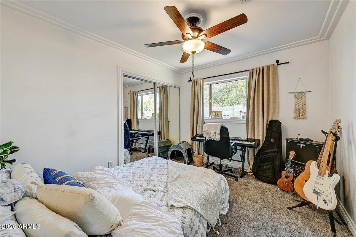 607 West 15th Street Tempe, AZ 85281 - Photo 24 of 29 a bedroom with a bed a large window and potted plant on the dresser