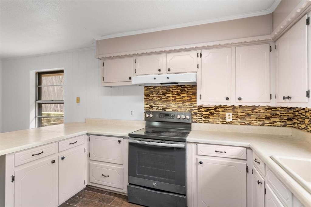 525 Pecan Lane Rowlett, TX 75089 - Photo 15 of 23 a kitchen with white cabinets and appliances