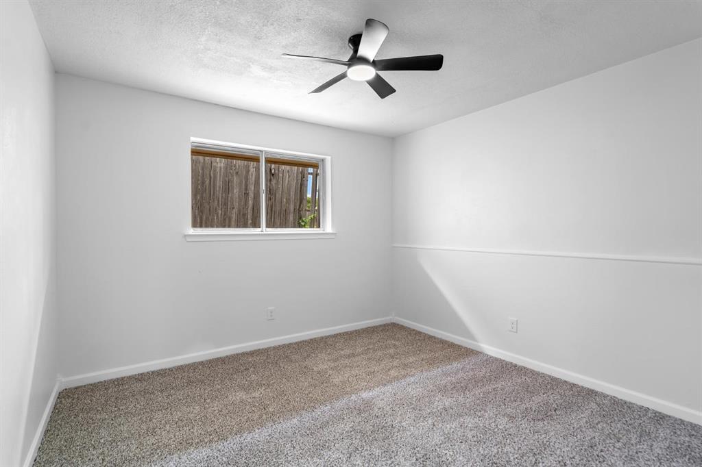 525 Pecan Lane Rowlett, TX 75089 - Photo 21 of 23 an empty room with a ceiling fan and window
