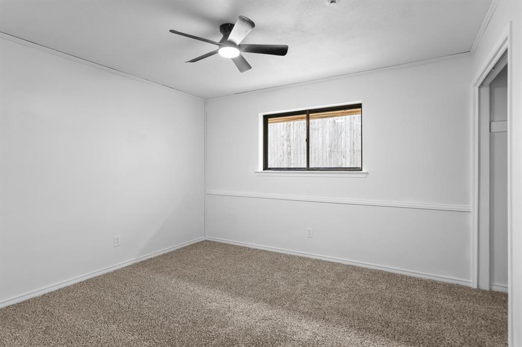525 Pecan Lane Rowlett, TX 75089 - Photo 22 of 23 an empty room with a window and a ceiling fan