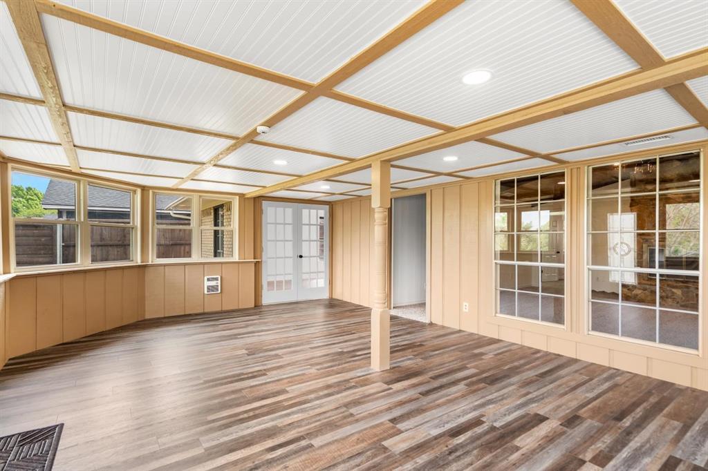 525 Pecan Lane Rowlett, TX 75089 - Photo 7 of 23 a view of an empty room with wooden floor and windows