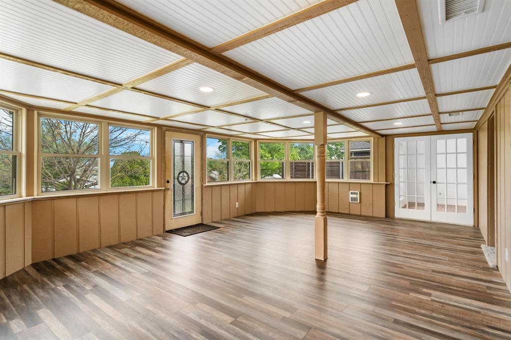 525 Pecan Lane Rowlett, TX 75089 - Photo 8 of 23 a view of an empty room with wooden floor and windows