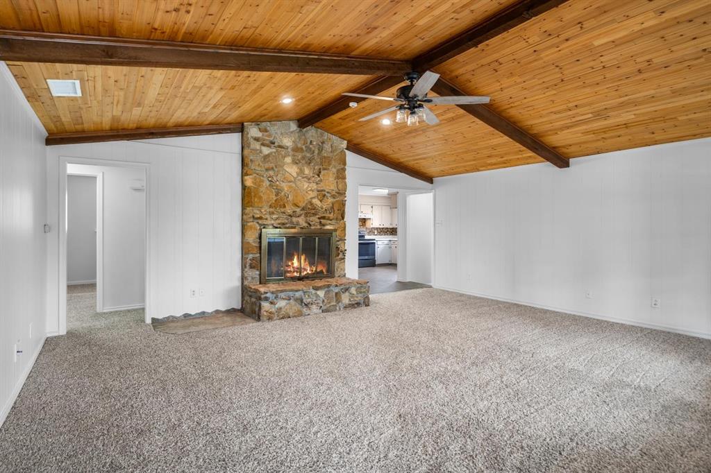 525 Pecan Lane Rowlett, TX 75089 - Photo 10 of 23 a view of an empty room with a fireplace and a fan