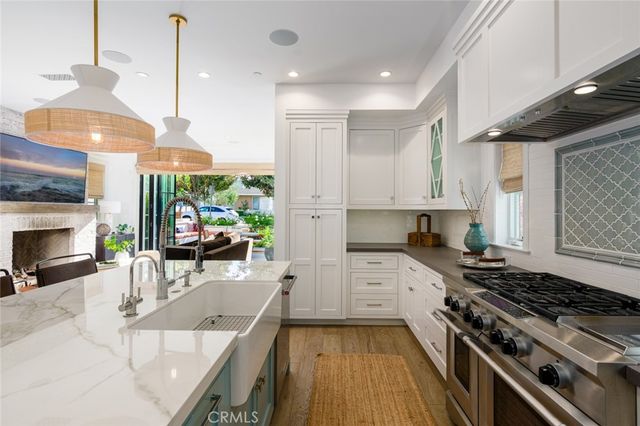 a kitchen with stainless steel appliances kitchen island granite countertop a sink stove and cabinets