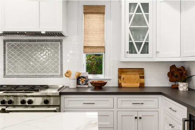 a kitchen with stainless steel appliances a stove a sink island and a refrigerator