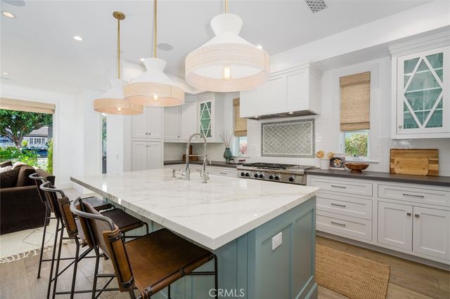 a kitchen with a stove and a white cabinet