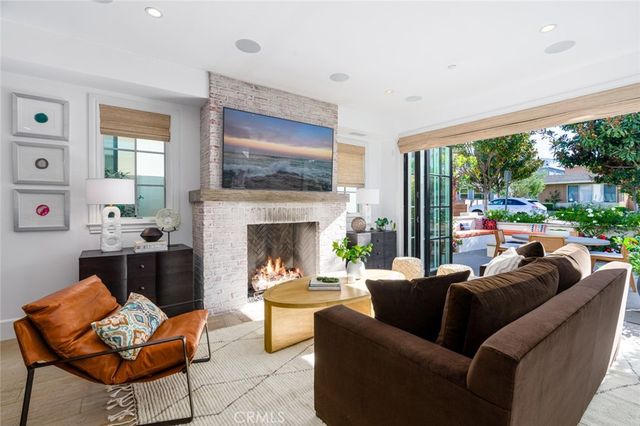 a living room with furniture a large window and a fireplace