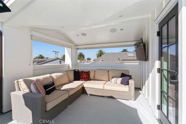 a living room with furniture and a ceiling fan