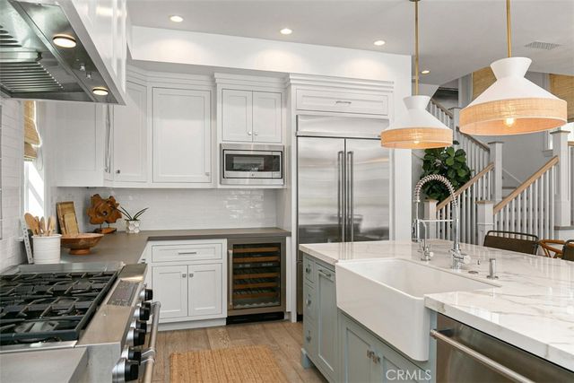 a kitchen with stainless steel appliances granite countertop a stove and a sink