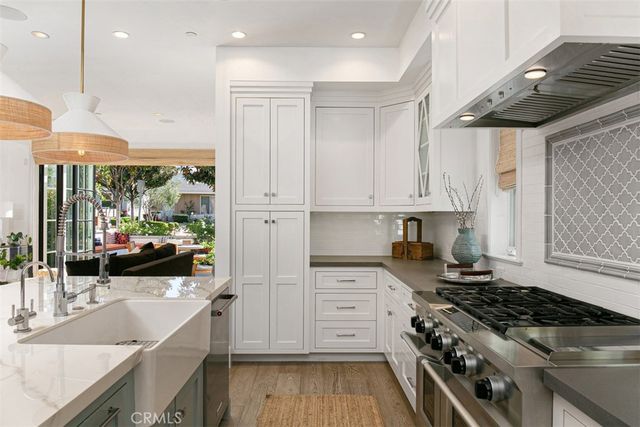a kitchen with a stove a sink and a refrigerator