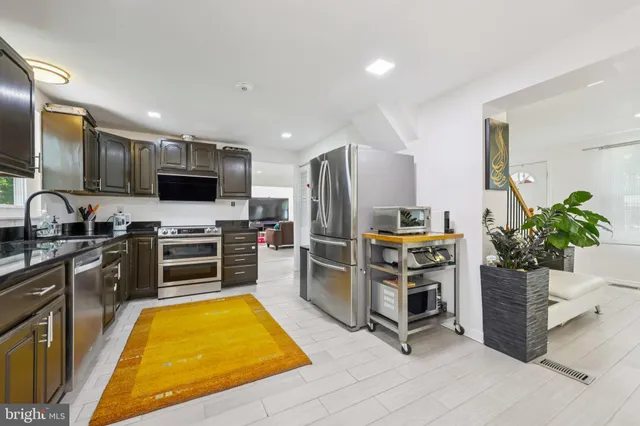 a kitchen with counter top space appliances and cabinets