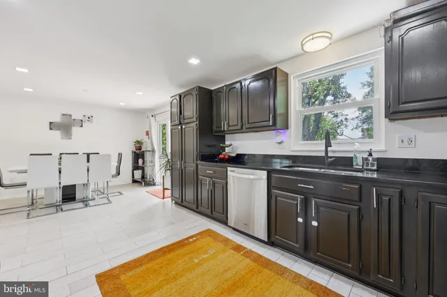 a kitchen with stainless steel appliances a sink stove and refrigerator