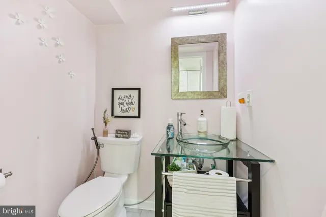 a bathroom with a toilet a sink and a mirror