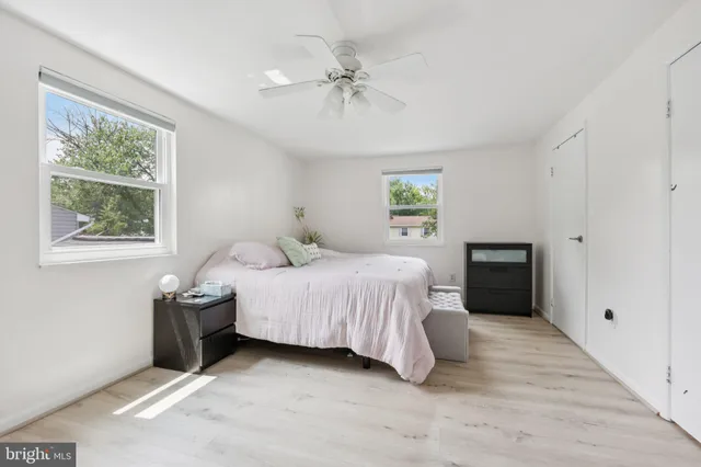 a spacious bedroom with a bed and a window