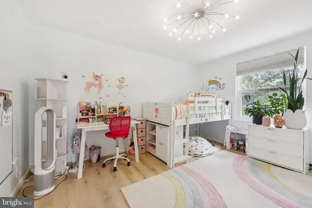 a bedroom with furniture and a chandelier