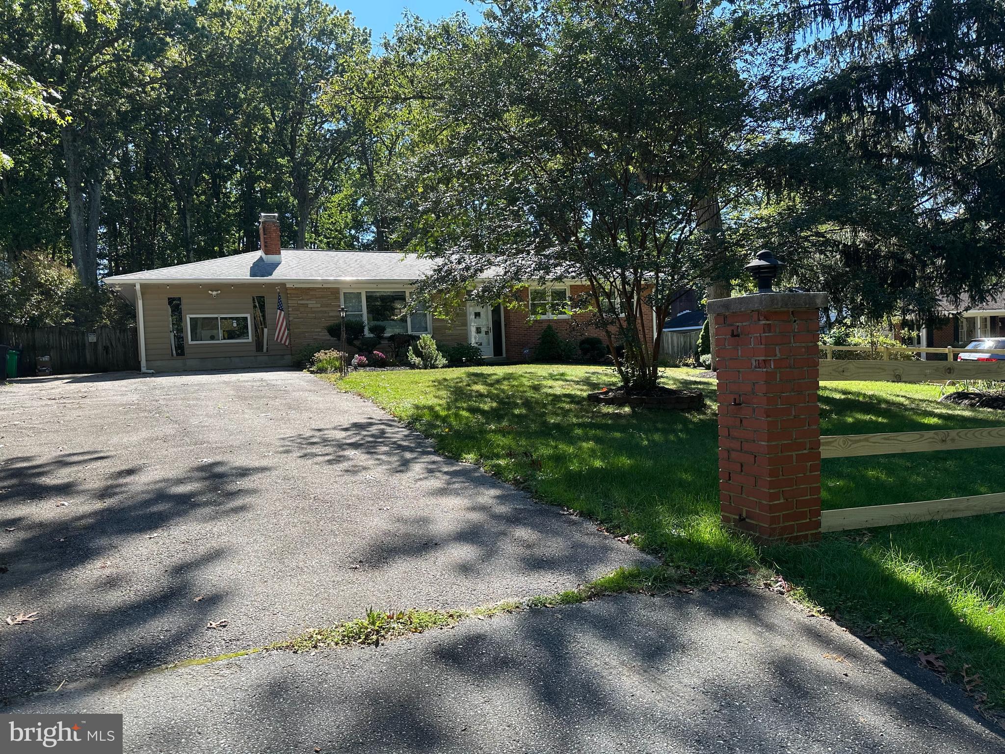 a front view of a house with a yard and tree