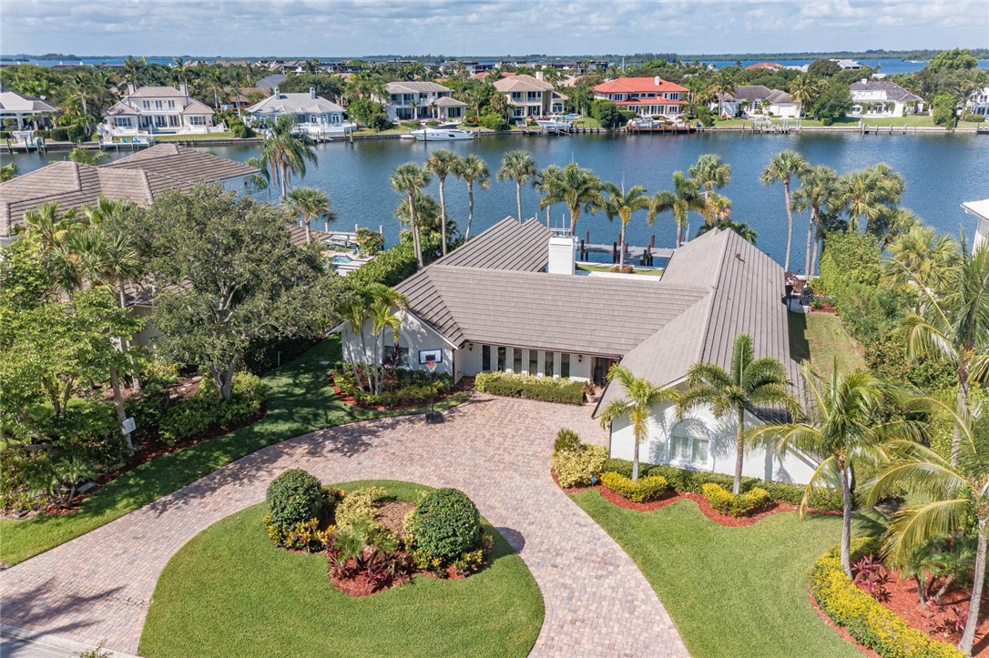 an aerial view of a house with outdoor space lake and outdoor seating