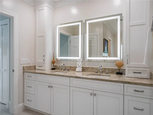 a bathroom with double sink and a mirror
