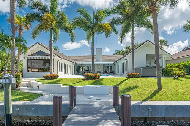a front view of a house with swimming pool having outdoor seating