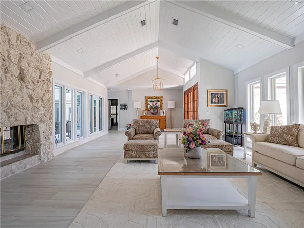 a living room with fireplace furniture and a large window