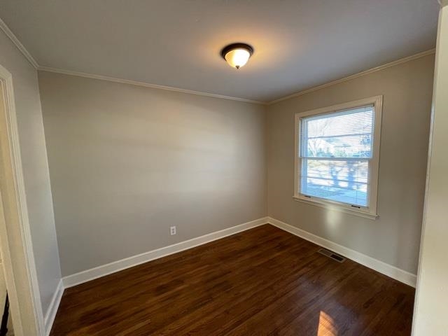1619 Gilson Road Memphis, TN 38117 - Photo 16 of 20 a view of an empty room with wooden floor and a window