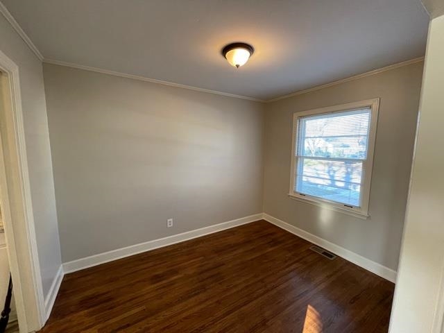1619 Gilson Road Memphis, TN 38117 - Photo 5 of 20 an empty room with wooden floor and windows