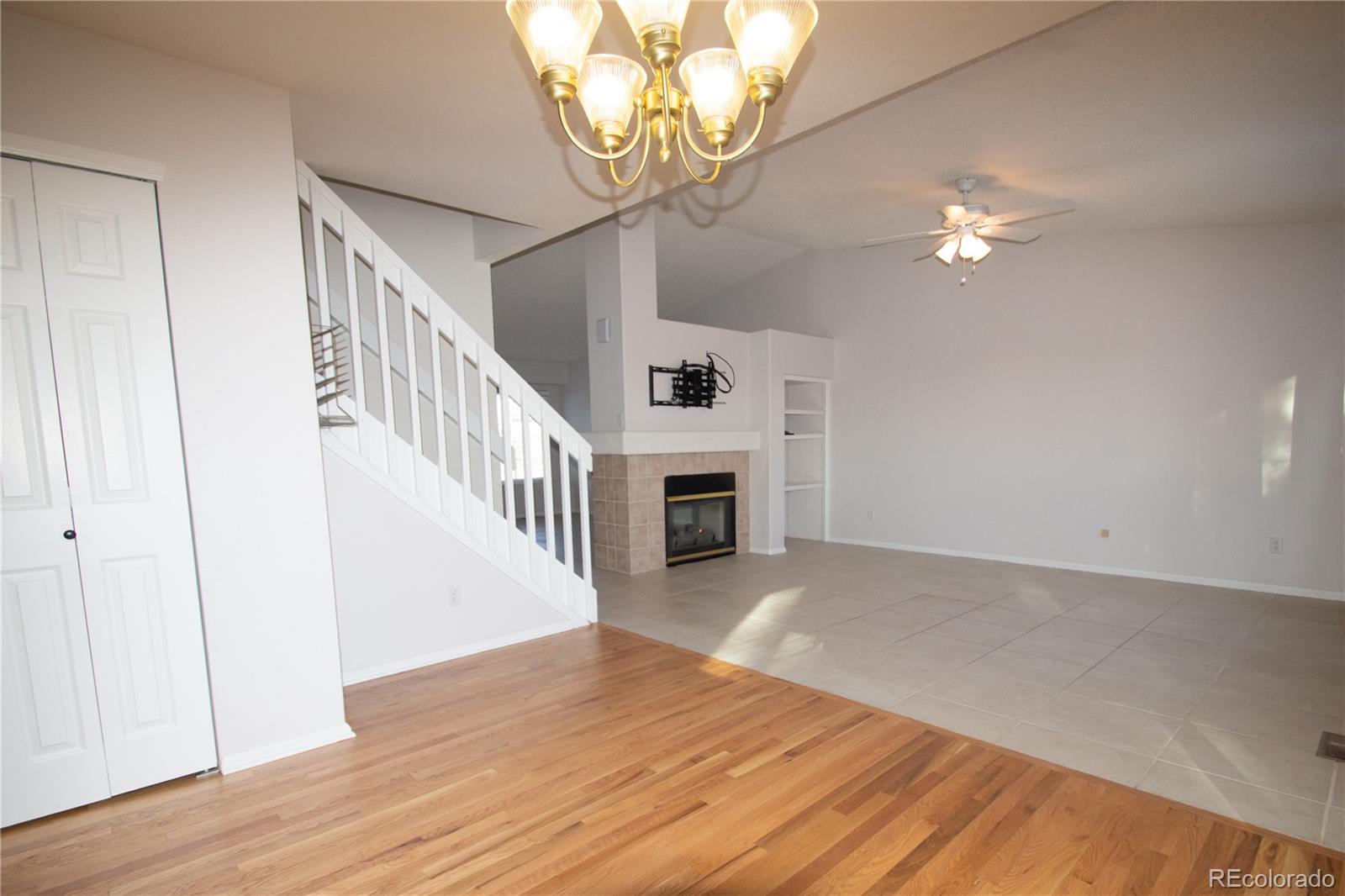 9608 South Castle Ridge Circle Highlands Ranch, CO 80129 - Photo 16 of 33 wooden floor in an empty room with a chandelier fan