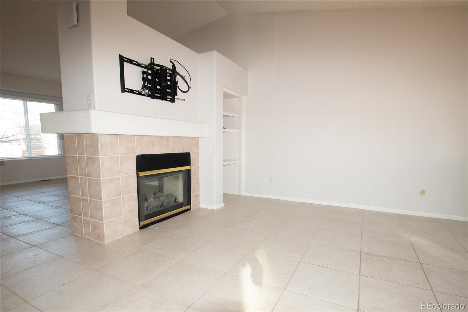 9608 South Castle Ridge Circle Highlands Ranch, CO 80129 - Photo 17 of 33 a view of an empty room with a fireplace