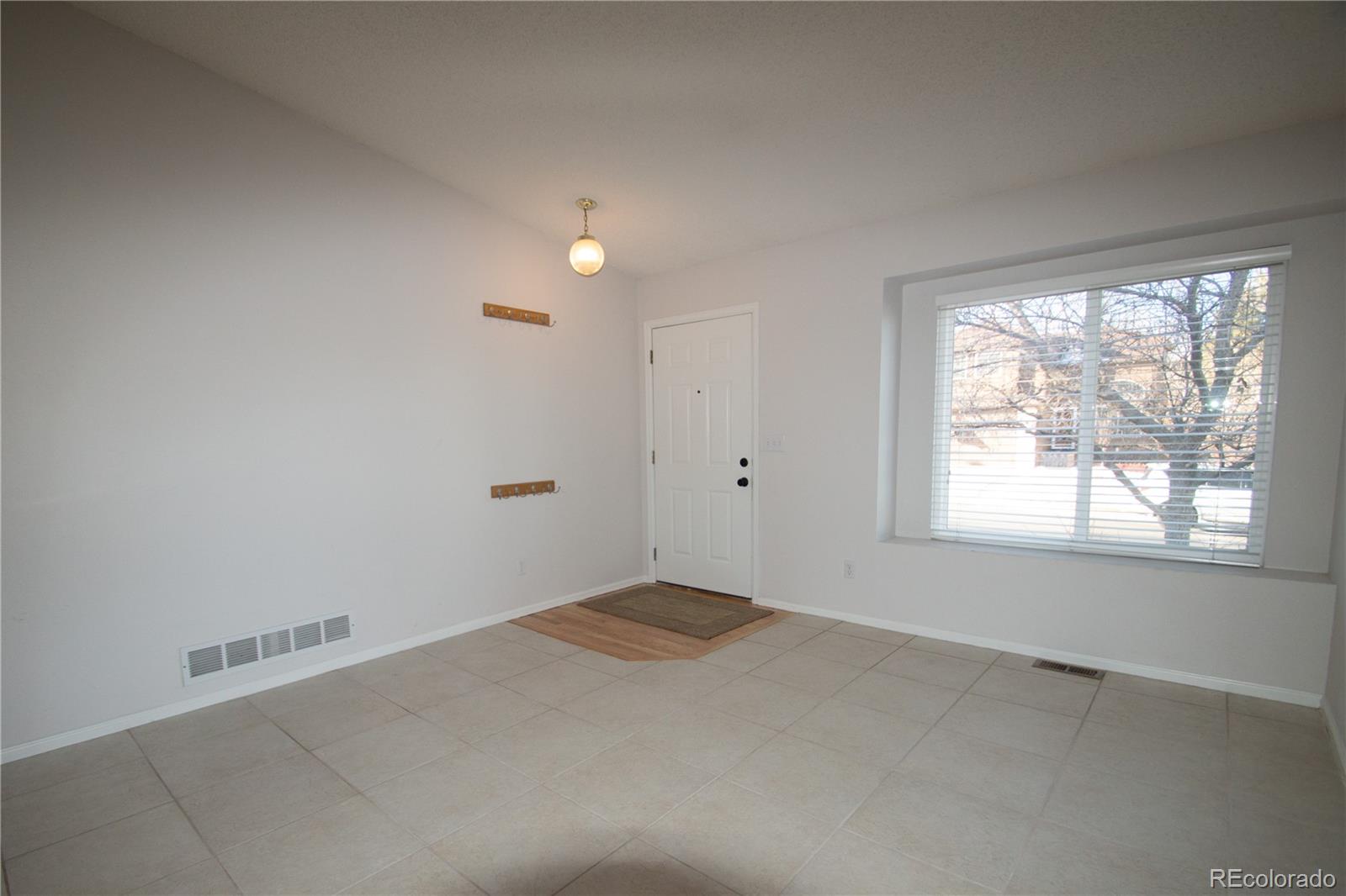 9608 South Castle Ridge Circle Highlands Ranch, CO 80129 - Photo 3 of 33 an empty room with a empty space and windows