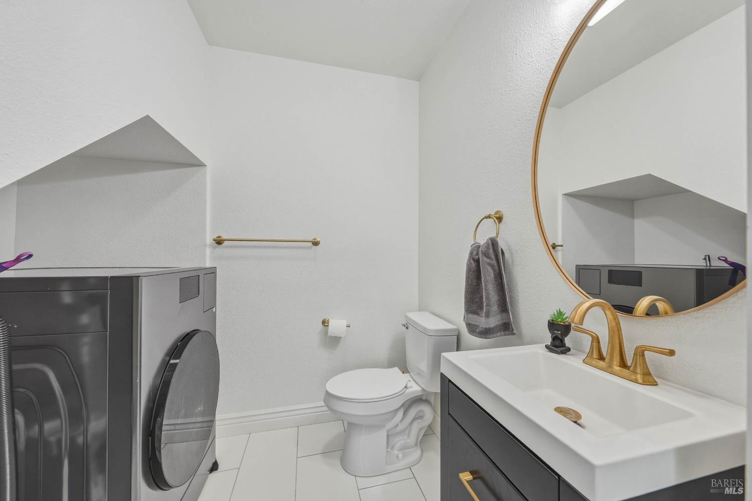107 Sebastopol Avenue Santa Rosa, CA 95407 - Photo 13 of 33 a bathroom with a toilet sink and mirror