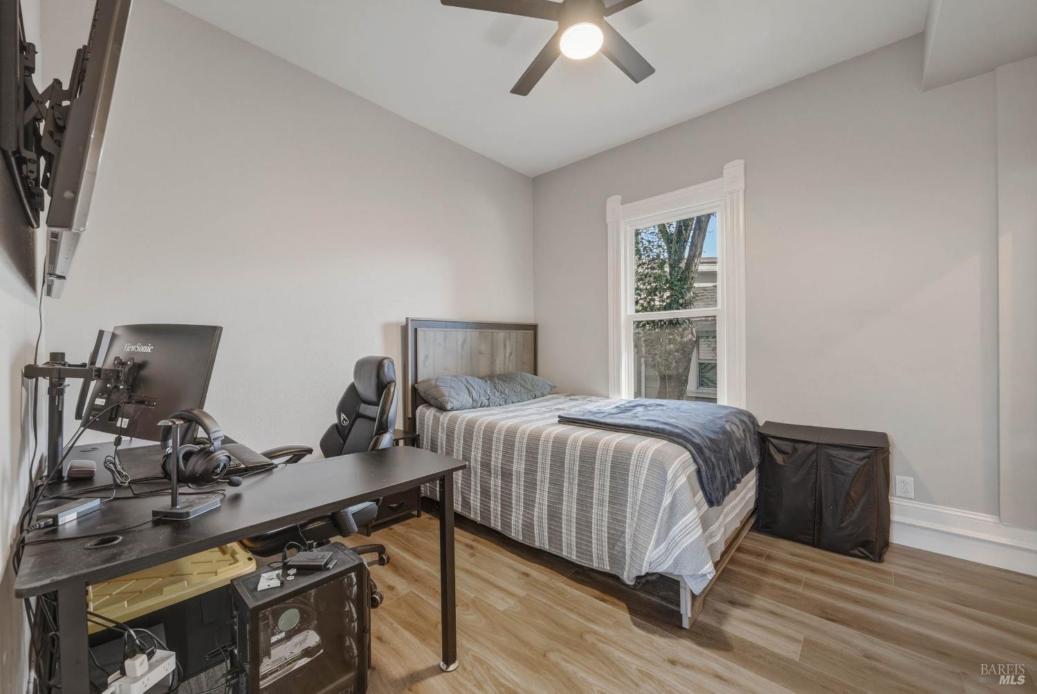 107 Sebastopol Avenue Santa Rosa, CA 95407 - Photo 15 of 33 a bedroom with a bed and a chandelier