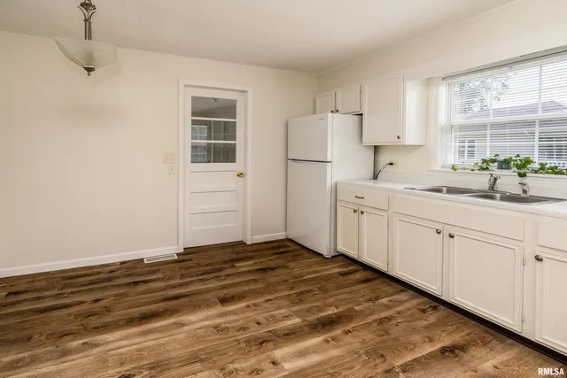 a kitchen with a sink cabinets and window