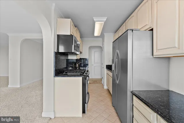 a view of a room with an empty room and wooden floor