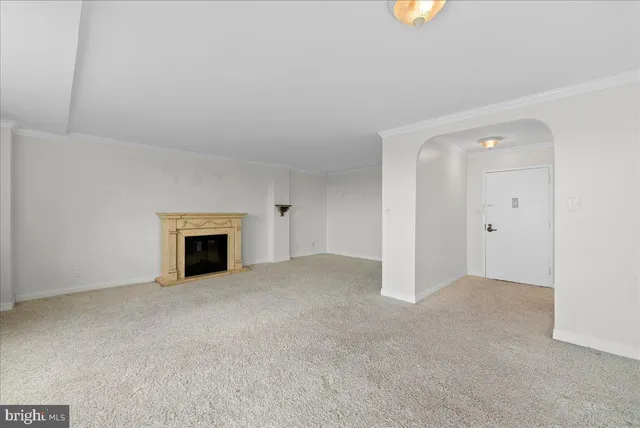 a view of an empty room with a fireplace