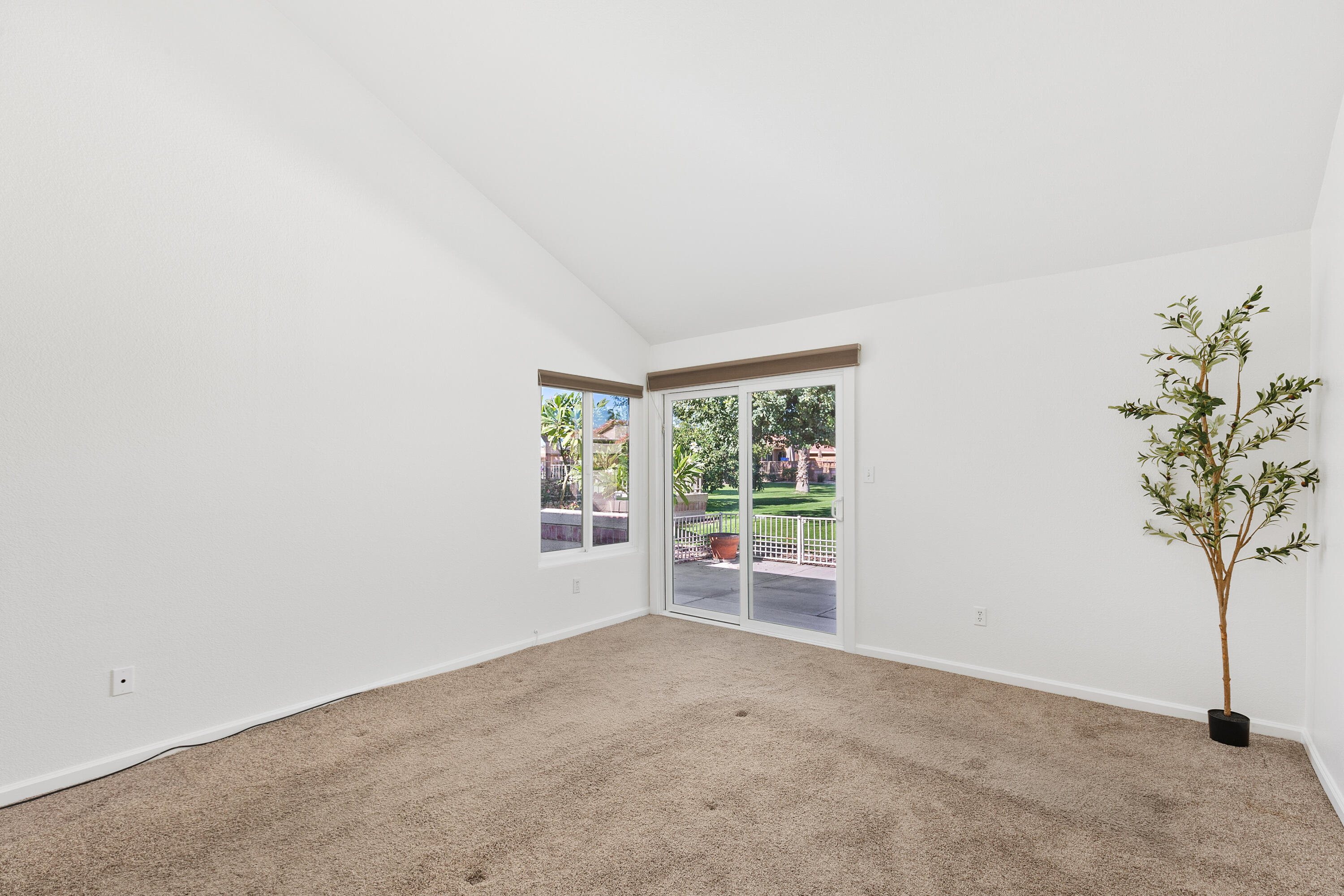 82288 Ullman Road Indio, CA 92201 - Photo 5 of 32 an empty room with windows and flower plants