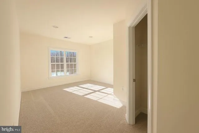 a view of an empty room and a window