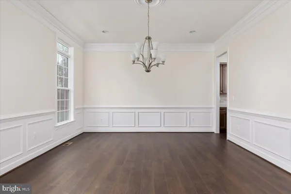 a view of room with window and hardwood floor