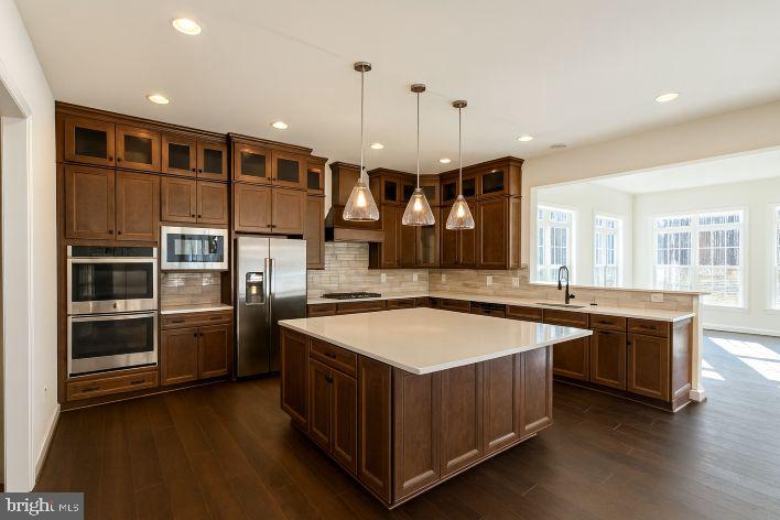 13620 Aden Road Nokesville, VA 20181 - Photo 3 of 31 a large kitchen with stainless steel appliances granite countertop a stove and a refrigerator