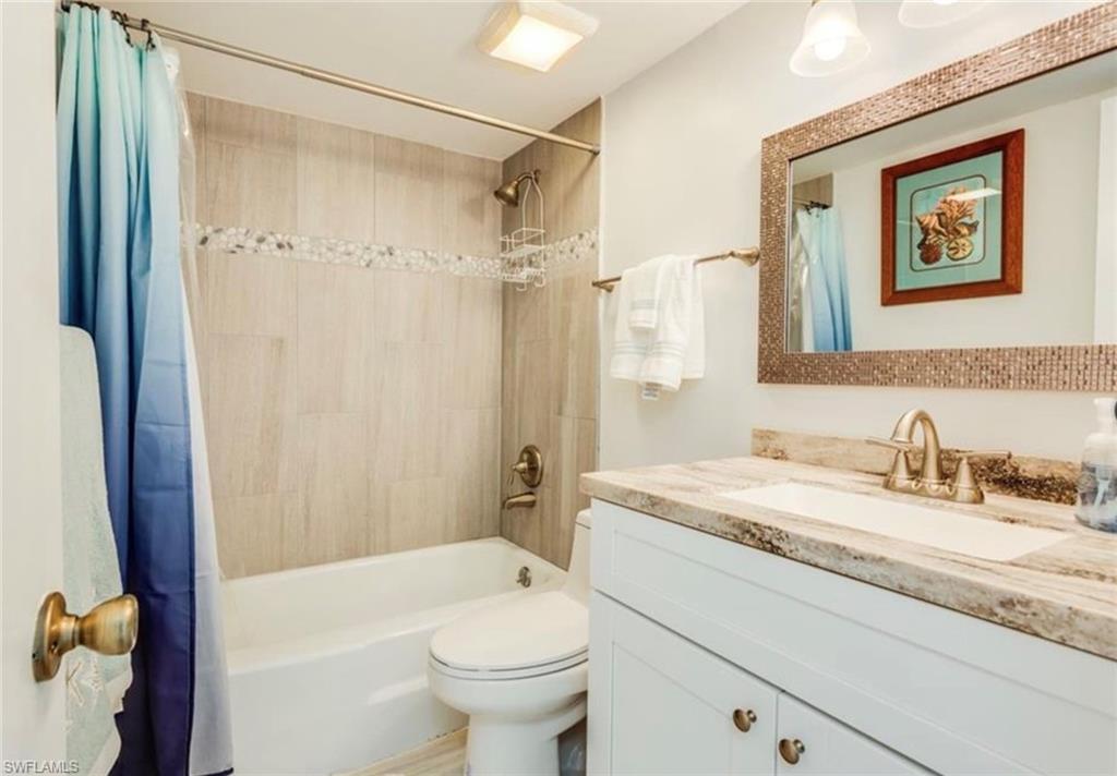 372 4th Avenue South, Unit 372 Naples, FL 34102 - Photo 12 of 14 Full bathroom featuring shower / bath combo and vanity