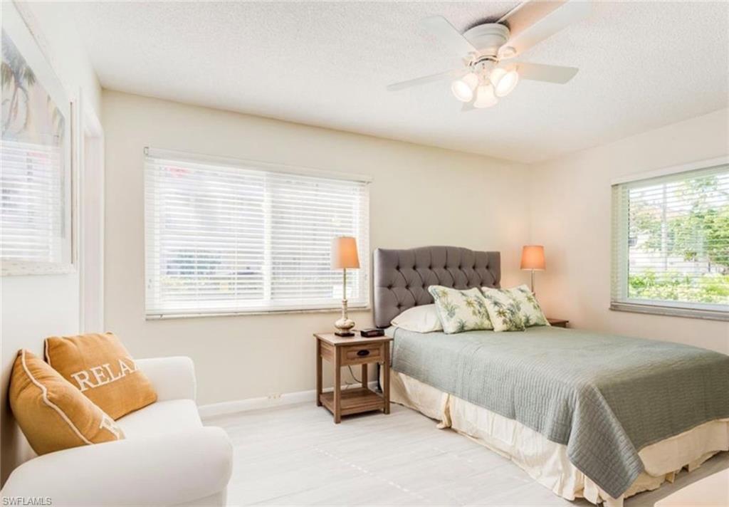 372 4th Avenue South, Unit 372 Naples, FL 34102 - Photo 6 of 14 Bedroom with ceiling fan and a textured ceiling